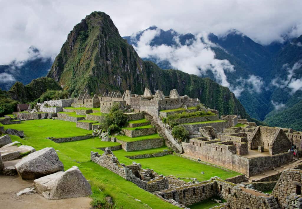 Llama in the foreground overlooking the ancient Inca citadel of Machu Picchu in the Peruvian Andes.