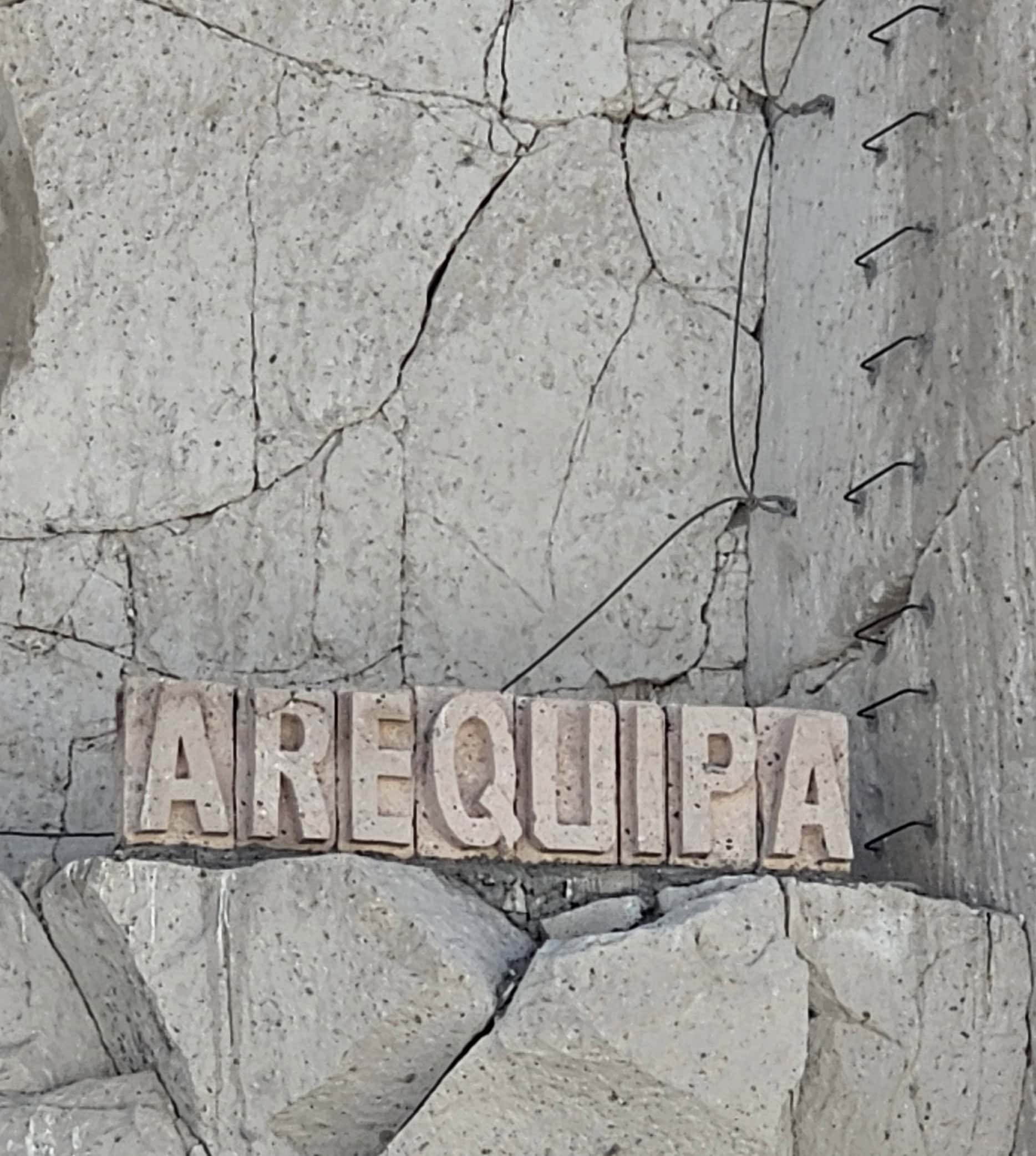 Arequipa sign carved from white volcanic stone at the Ruta del Sillar quarry near Arequipa, Peru