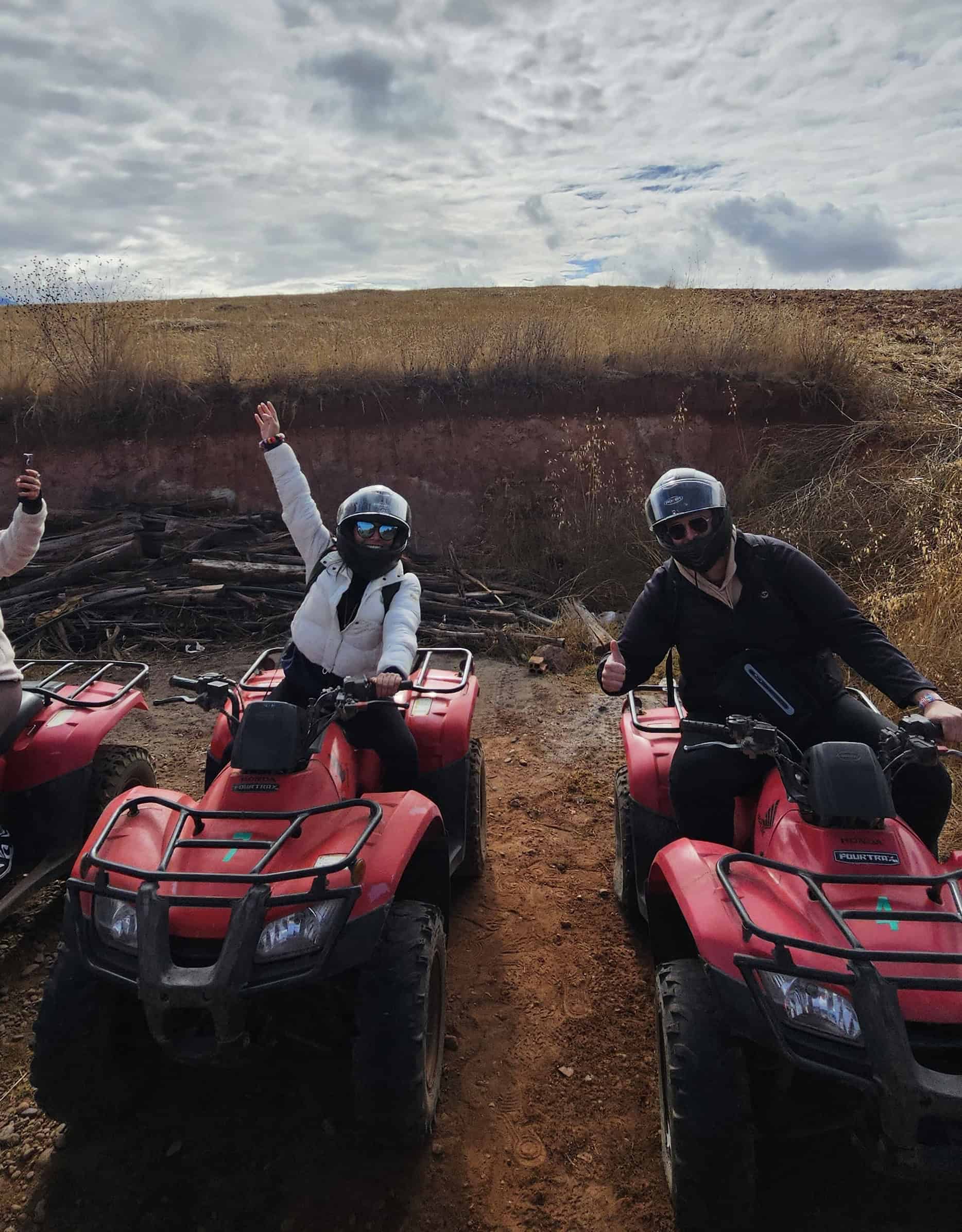 Travelers riding quad bikes through the countryside near Moray and Maras in the Sacred Valley near Cusco, Peru