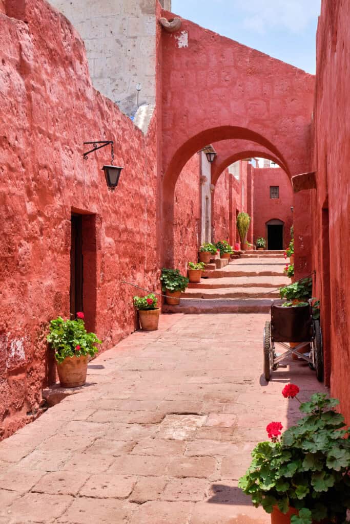 Santa Catalina Monastery Arequipa Peru with red walls, arches, and courtyard walkway
