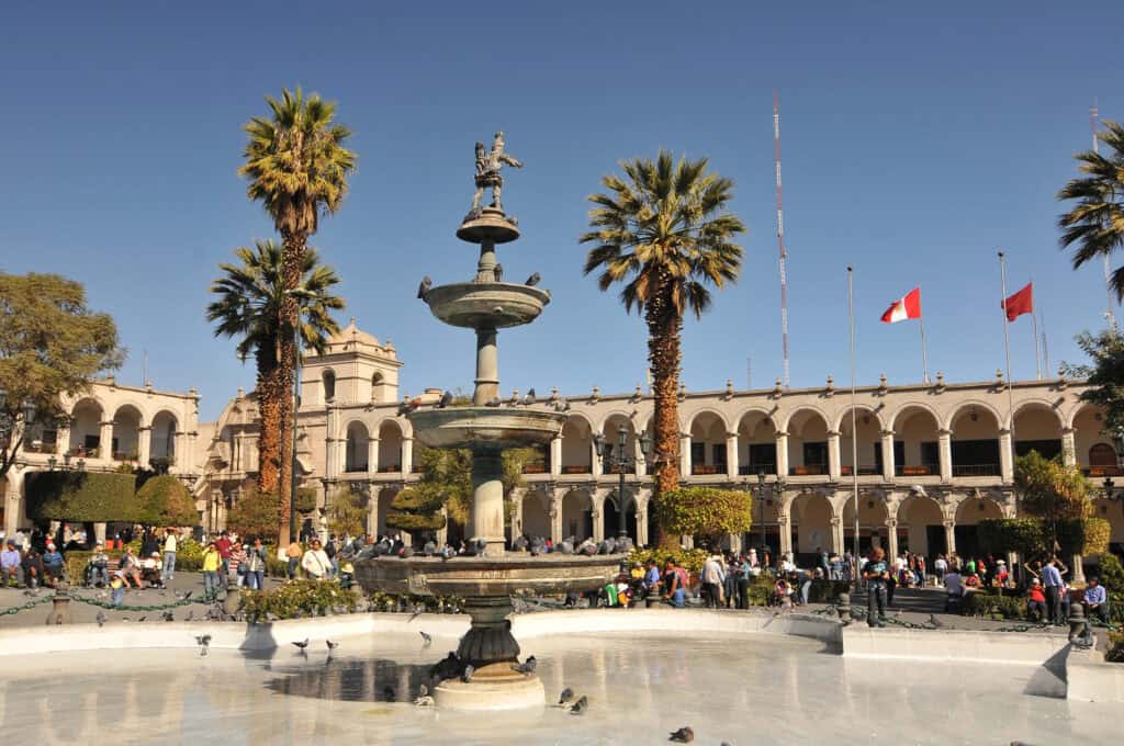 Plaza de Armas Arequipa Peru with historic architecture, fountain, and palm trees
