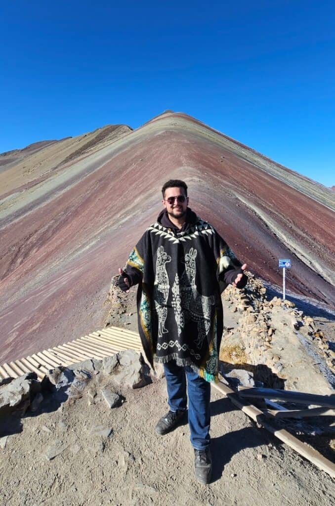 Yacin posing in front of the famous rainbow mountain
