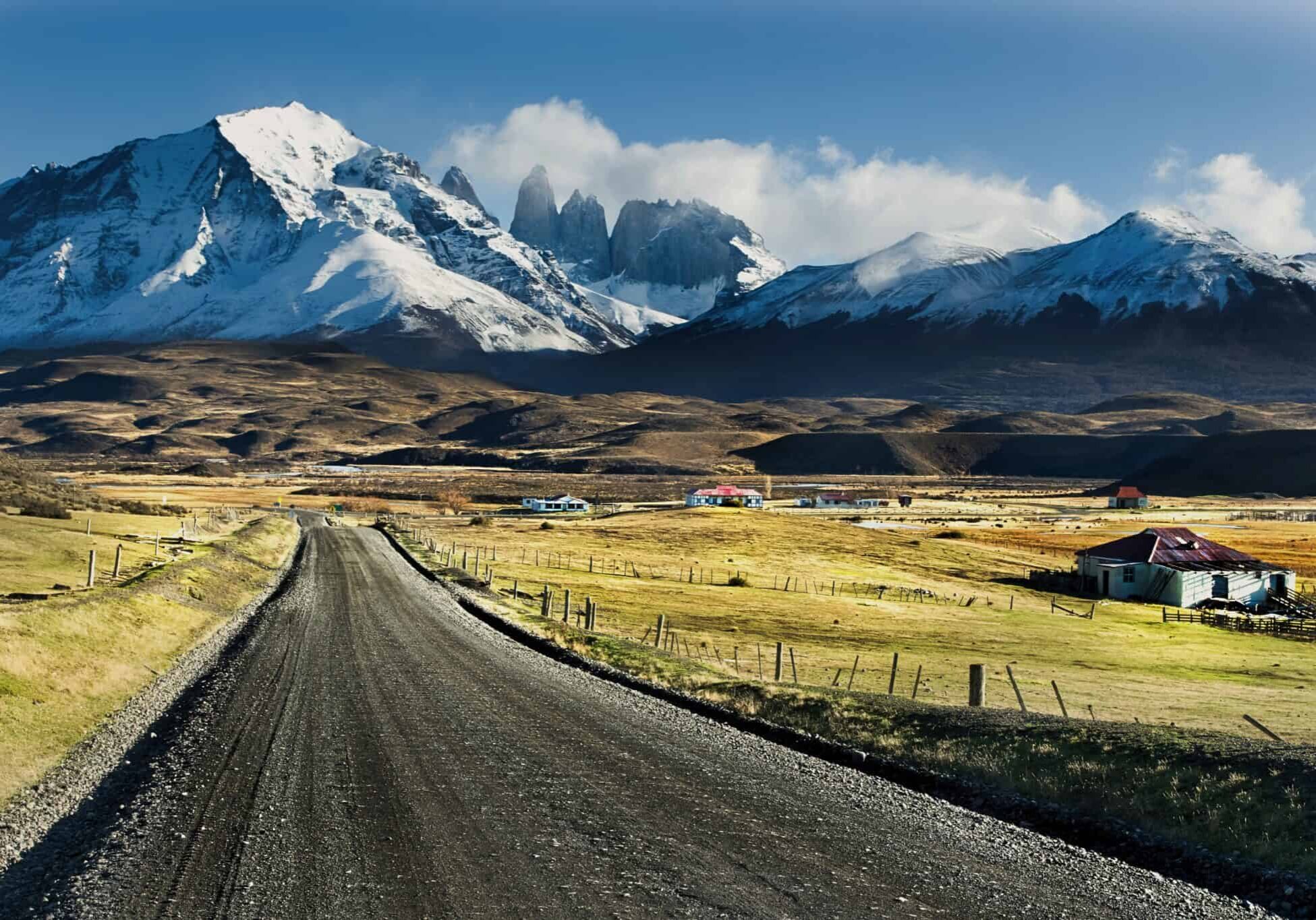 Open road through a South America mountain landscape with snow-capped peaks